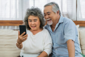 Asian couple Grandparent taking Video call to grandchild-Tips for long-distance caregivers