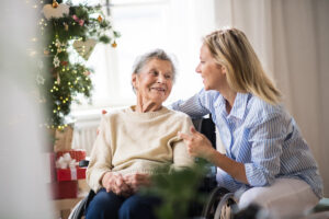 Daughter smiling at older mother-Christmas decorations in background