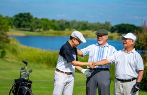 Group of Asian people businessman and senior CEO enjoy outdoor sport lifestyle golfing together at golf country club.