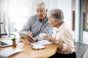 Making sound financial decisions. High angle shot of a senior couple working on their finances at home.